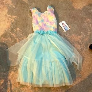 This dress has never been worn and still has the the tags. It is a size girls 12